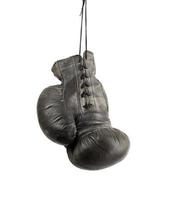 very old black right boxing glove hanging on a cord isolated on white background photo