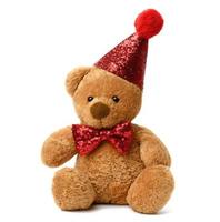lindo oso marrón de peluche con una gorra roja brillante y una corbata de moño alrededor del cuello foto