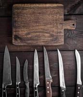 used kitchen knives and  cutting board photo