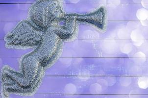 Figure angel of shiny particles on a  purple background photo