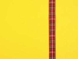 red ribbon in the box on a yellow background photo