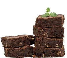 two stacks with square baked pieces of chocolate brownie with walnuts photo