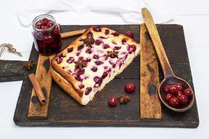 pie from cottage cheese and cherries on a brown board photo