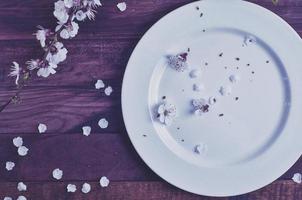 White empty plate on a brown wooden surface photo