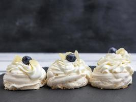 baked round meringues with whipped cream photo