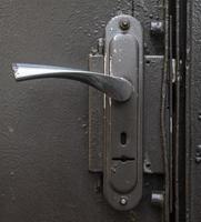 iron handle on the green metal doors photo