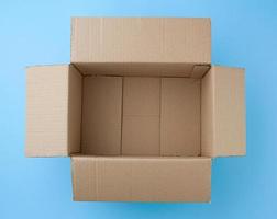open empty square brown cardboard box for transportation and packaging of goods photo