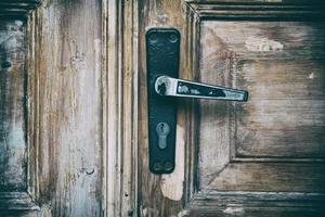 wooden door with an iron lock and an iron handle photo