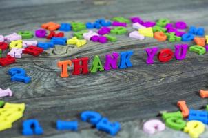 Colorful wooden letters on a gray surface photo