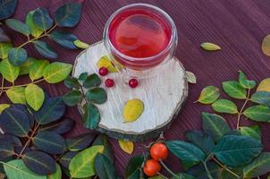 Fruit tea with berries viburnum on a wooden surface photo