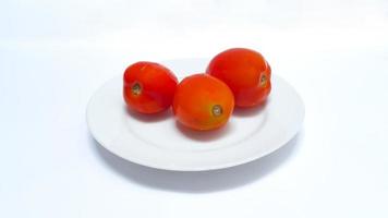 Close up of tomatoes on a plate isolated on white background