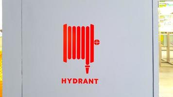 Fire hydrant for fire emergency. Red fire hydrant icon on the wall. photo