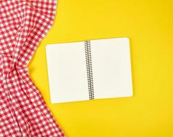 red textile napkin and open notebook, photo