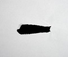 white sheet of paper with a hole, full frame photo