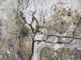 fragment of gray cement wall with cracks, full frame photo