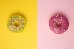 round different donuts with sprinkles on a bright multi-colored background photo