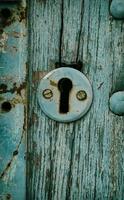 Vintage keyhole in a old door photo