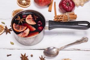 mulled wine in an aluminum ladle with a handle photo