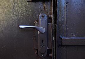 Iron door handle on iron gray doors photo