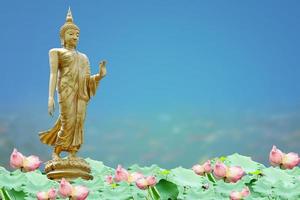 Makha Asanaha Visakha Bucha Day Golden Buddha image. Background of Bodhi leaves with shining light. Soft image and smooth focus style photo