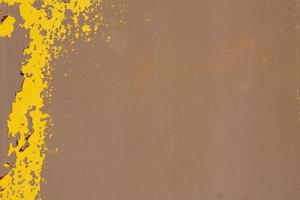 Yellow steel plate, rough surface, peeling paint, showing rusty steel texture. abstract background. photo