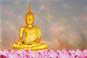 Makha Asanaha Visakha Bucha Day Golden Buddha image. Background of Bodhi leaves with shining light. Soft image and smooth focus style photo