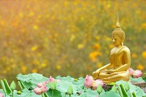 Makha Asanaha Visakha Bucha Day Golden Buddha image. Background of Bodhi leaves with shining light. Soft image and smooth focus style photo