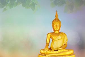 Makha Asanaha Visakha Bucha Day Golden Buddha image. Background of Bodhi leaves with shining light. Soft image and smooth focus style photo