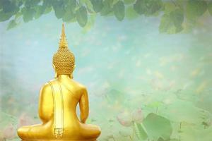 Makha Asanaha Visakha Bucha Day Golden Buddha image. Background of Bodhi leaves with shining light. Soft image and smooth focus style photo