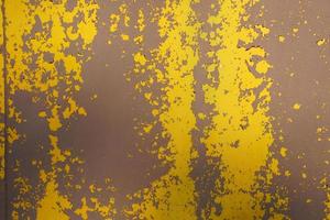 Yellow steel plate, rough surface, peeling paint, showing rusty steel texture. abstract background. photo