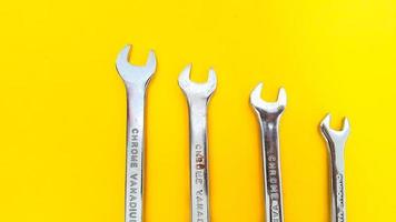 Various sizes of wrench or spanner isolated on yellow background. Mechanical Tool. photo