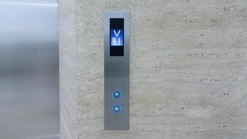 Elevator button up and down with screen indicating the B1 floor photo