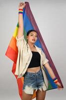 Pretty woman LGBQ pose with muli-color flag photo