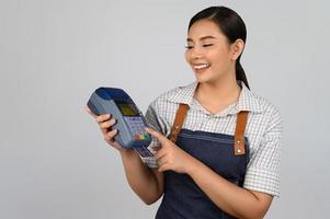 Portrait of young asian woman in waitress uniform pose with credit card