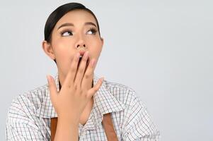 Portrait of young asian woman in waitress costume in surprise gesture photo