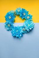 Blue and yellow background with blue flowers on it. Stand with Ukraine