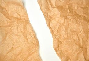 torn crumpled brown parchment paper, white background photo