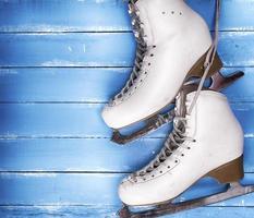 a pair of worn white leather skates for figure skating photo