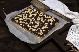 baked chocolate cake sprinkled with almonds photo