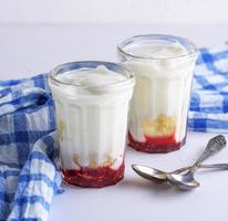 homemade yogurt with jam in a glass jar photo