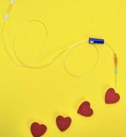 plastic catheter with needle and red heart photo