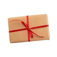 rectangular box wrapped in brown paper and tied with a red bow, gift isolated on white background, template for designer,  great design for any purposes photo