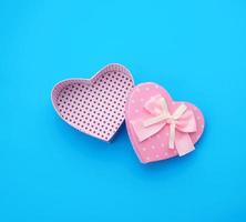 open empty cardboard box in the form of a heart on a light blue background photo