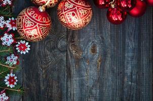 New Year and Christmas background with toys and spruce branches on a gray wooden background photo