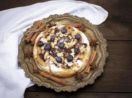 round baked pie with apples and blueberries photo