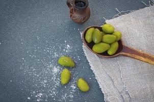 Olive oil and green olives photo