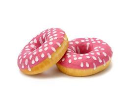 baked round donut with pink icing and white dots isolated on white background photo