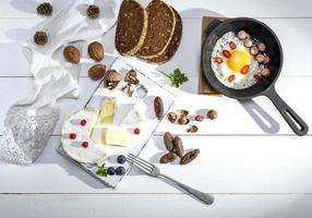 camembert cheese and a round frying pan with a fried chicken egg photo