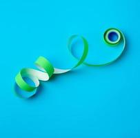 untwisted reel with green sticky stickers on a blue background photo