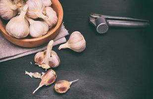 Fruit of garlic in a wooden bowl photo
